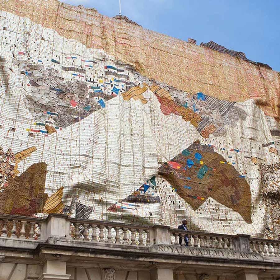 El Anatsui in front of TSIATSIA - searching for connection, 2013. Aluminium (bottle-tops, printing plates, roofing sheets) and copper wire, 15.6 x 25 m at the Royal Academy of Arts, 2013.